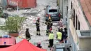 Petugas pemadam kebakaran berada di lokasi robohnya sebuah rumah susun di Milan, Italia, Minggu (12/6) waktu setempat. Tiga orang yang tinggal di bangunan itu tewas akibat ledakan yang berasal dari lantai tiga bangunan tersebut. (REUTERS/Flavio Lo Scalzo)
