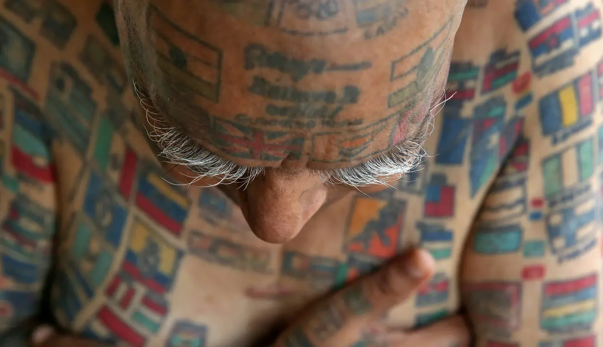 Guinness Rishi, kakek berumur 74 tahun ini menunjukan tato di tubuhnya di apartemennya di New Delhi, India (20/5). Guinness Rishi merupakan pemegang rekor dunia yang paling banyak menato bendera negara dari seluruh dunia. (REUTERS/Cathal McNaughton)