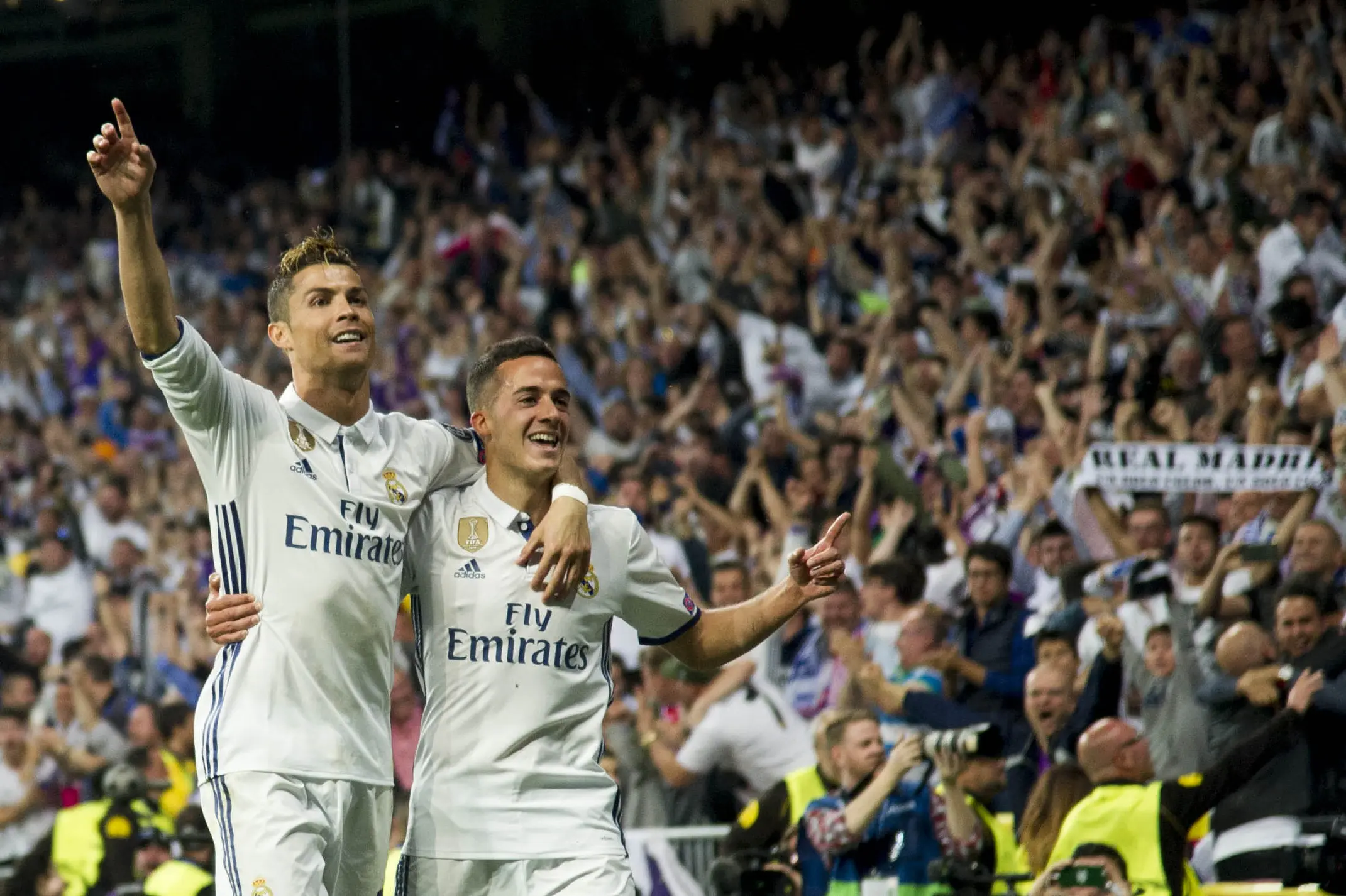 Penyerang Real Madrid Cristiano Ronaldo merayakan golnya ke gawang Atletico Madrid bersama Lucas Vazquez. (CURTO DE LA TORRE / AFP)