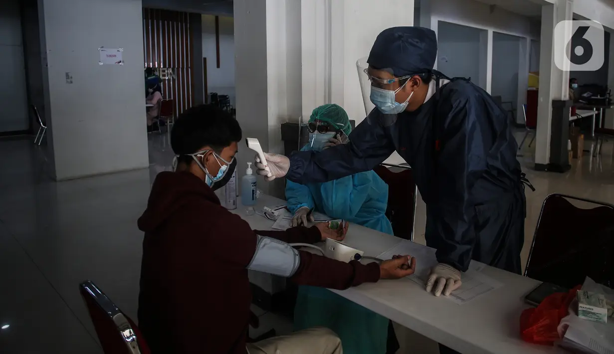 Tenaga kesehatan melakukan screening ke calon penumpang sebelum disuntikkan vaksin COVID-19 di Stasiun Pasar Senen, Jakarta, Minggu (4/7/2021). PT Kereta Api Indonesia Daop 1 Jakarta membuka layanan vaksinasi Covid-19 bagi penumpangnya di Stasiun Gambir dan Pasar Senen. (Liputan6.com/Johan Tallo)