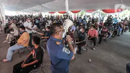 Petugas menggunakan toak saat mengimbau warga agar tidak berkerumun saat vaksinasi Covid-19 di Pelabuhan Sunda Kelapa, Jakarta, Kamis (10/6/2021). Vaksinasi diharapkan dapat memberikan perlindungan terhadap warga serta mencegah penyebaran virus di kawasan pesisir. (merdeka.com/Iqbal S. Nugroho)