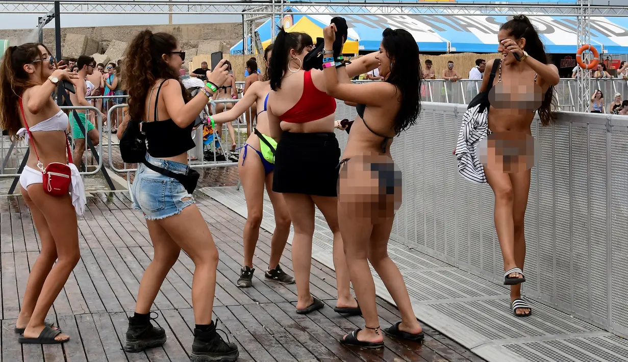 Sejumlah wanita berjoget di sebelah kolam renang selama Arenal Sound Music Festival 2019 di Burriana, Spanyol (31/7/2019). Festival musik  menampung ratusan ribu orang. (AFP Photo/Jose Jordan)