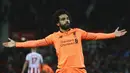 Pelatih Real Madrid, Zinedine Zidane tertarik melihat potensi bintang Liverpool, Mohamed Salah. Zidane pun membuka peluang untuk membicarakan kepindahan Salah ke Madrid. (AFP/ Geoff Caddick)