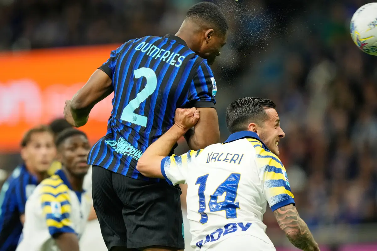 Pemain Inter Milan Denzel Dumfries menyundul bola di depan pemain Parma Emanuele Valeri