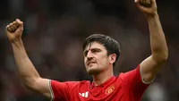 Bek Manchester United, Harry Maguire, merayakan gol kedua timnya dalam pertandingan Premier League antara Manchester United dan Ipswich Town di Old Trafford, Manchester, barat laut Inggris, Minggu (30/8/2026). (AFP/Paul Ellis)