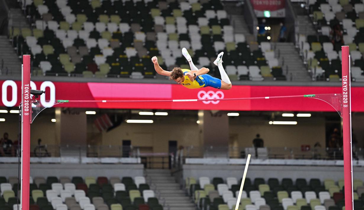 Atlet lompat galah asal Swedia Armand Duplantis bertanding di final lompat galah putra pada Olimpiade Tokyo 2020 di Olympic Stadium, Tokyo, Selasa (3/8/2021). (Foto: AFP/Andrej Isakovic)