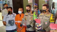 Polisi mengapit tersangka pembunuhan teman kerja di Kota Malang gara - gara sakit hati saat bermain game online (Liputan6.com/Zainul Arifin)