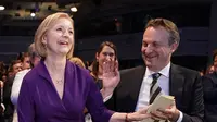 Pemimpin Partai Konservatif baru dan Perdana Menteri terpilih Inggris Liz Truss (kiri) bereaksi di samping suaminya Hugh O'Leary ketika dia mendengar pengumuman pemenang kontes kepemimpinan Partai Konservatif di pusat kota London pada 5 September 2022. (STEFAN ROUSSEAU / POOL / AFP)