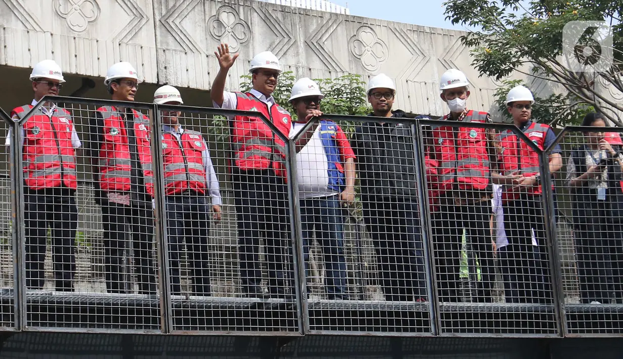 Gubernur DKI Jakarta Anies Baswedan melambaikan tangan saat meninjau jalur pejalan kaki pada soft launching fasilitas pejalan kaki dan pesepeda pada proyek pembangunan dan penataan kawasan Semanggi di Taman Semanggi, Jakarta, Rabu (12/10/2022). Anies Baswedan menyatakan pembangunan fasilitas pejalan kaki dan jalur sepeda itu bertujuan untuk memberikan ruang interaksi dan oase baru bagi warga Ibu Kota dan sekitarnya. (Liputan6.com/Herman Zakharia)