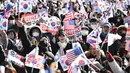Para pendukung Presiden Korea Selatan yang dimakzulkan, Yoon Suk Yeol, melambaikan bendera Amerika Serikat dan Korea Selatan saat mereka berkumpul di dekat kediaman kepresidenan di Seoul pada tanggal 31 Desember 2024. (JUNG YEON-JE/AFP)