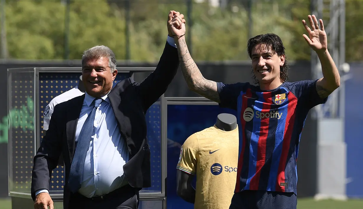 Presiden Barcelona Joan Laporta (kiri) dan pemain barunya Hector Bellerin bersorak saat diperkenalkan secara resmi menjelang Liga Champions kontra Viktoria Plzen di Ciudad Deportiva dekat Barcelona pada 6 September 2022. Kedatangan bek 27 tahun ini bakal mengisi pos bek kanan Barca menyusul kepergian Sergino Dest. (Photo by Josep LAGO / AFP)