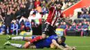 7. Bek Chelsea, Gary Cahill, terjatuh berebut bola dengan pemain Southampton, Charlie Austin pada laga Liga Premier Inggris di Stadion St Mary, Sabtu (27/2/2016). Southampton takluk 1-2 dari Chelsea. (Reuters/Dylan Martinez)
