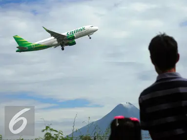 Warga menyaksikan pesawat komersial take off dari bandara Adisucipto,Yogyakarta, (6/2).Setelah di tutup pada 5/2 sore kemaren akibat cuaca buruk, bandara di buka kembali mengantisipasi lonjakan penumpang jelang liburan imlek. (Liputan6.com/Boy Harjanto)