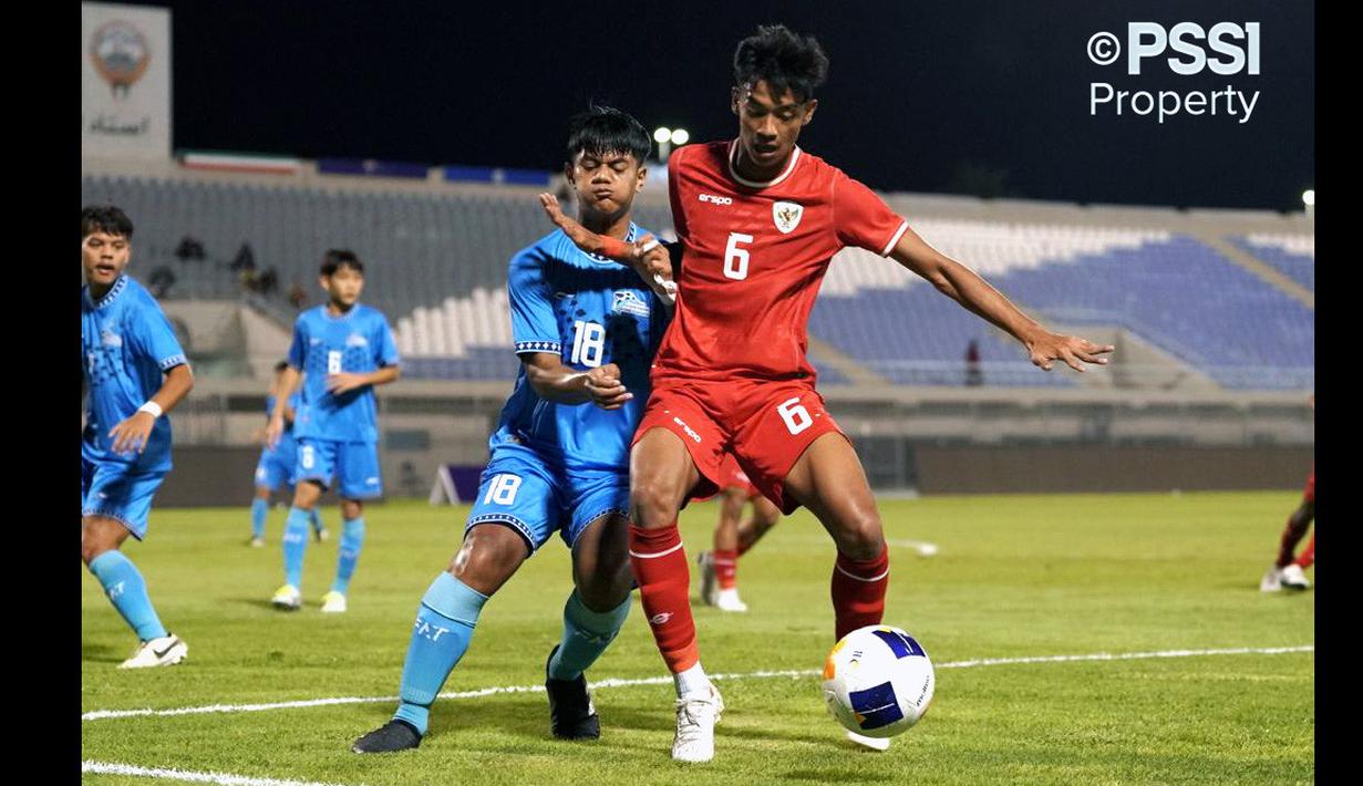 Pemain Timnas Indonesia U-17, Evandra Florasta (kanan) mengontrol bola dibayangi pemain Kepulauan Mariana Utara, Jayson Tagabuel pada laga Grup G Kualifikasi Piala Asia U-17 yang berlangsung di Abdullah Alkhalifa Alsabah Stadium, Mishref, Kuwait, Jumat (25/10/2024) WIB. (Dok. PSSI)