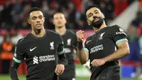Ekspresi pemain Liverpool Mohamed Salah (kanan) setelah membobol gawang Girona pada matchday 6 Liga Champions 2024/2025, Rabu (11/12/2024) dini hari WIB. (Josep LAGO / AFP)