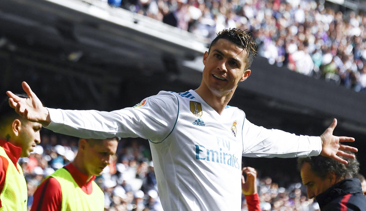 Bintang Real Madrid, Cristiano Ronaldo, merayakan gol yang dicetaknya ke gawang Atletico Madrid pada laga La Liga Spanyol di Stadion Santiago Bernabeu, Madrid, Minggu (8/4/2018). Kedua klub bermain imbang 1-1. (AFP/Gabriel Bouys)