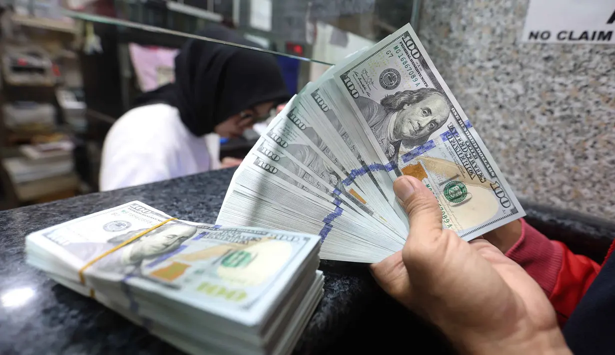 Batas pembelian dolar AS tanpa underlying akan diturunkan dari semula 50.000 menjadi 25.000 dolar AS per orang per bulan. Tampak dalam foto, karyawan menunjukkan uang pecahan dolar Amerika Serikat (AS) di salah satu gerai penukaran mata uang asing, Jakarta, Rabu (5/5/2026). (Kapanlagi.com/Budy Santoso)