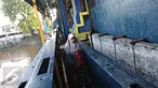 Warga melintasi jalan setapak di pintu air Petamburan, Jakarta, Jumat (17/2). Warga terpaksa melewati pintu air karena tidak ada jembatan penyeberangan orang di kawasan tersebut. (Liputan6.com/Immanuel Antonius)
