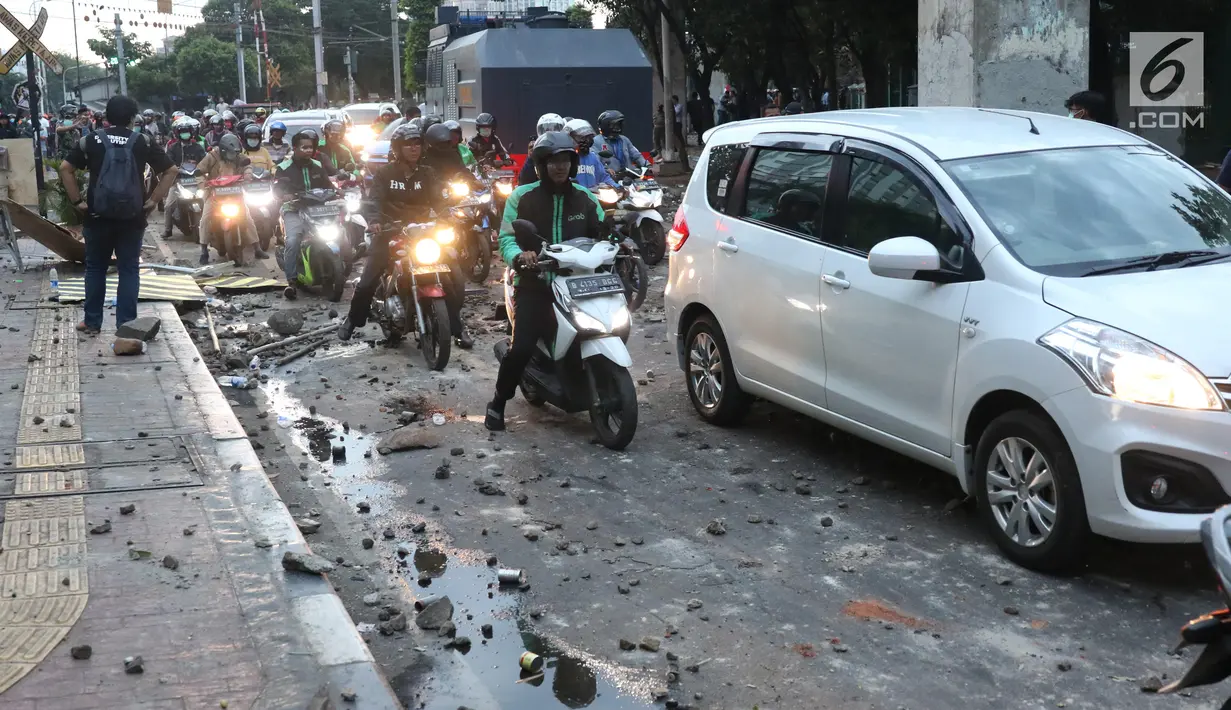 Kendaraan melintasi jalan di sekitar Stasiun Palmerah, Jakarta Barat, Senin (30/9/2019). Jalur di kawasan itu telah dibuka, namun kendaraan harus berhati-hati karena banyaknya batu sisa bentrokan massa di belakang gedung DPR yang berakhir ricuh. (Liputan6.com/Angga Yuniar)