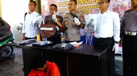 Pencuri pistol polisi (baju orange) dengan modus pecah kaca mobil di Polresta Pekanbaru. (Liputan6.com/M Syukur)