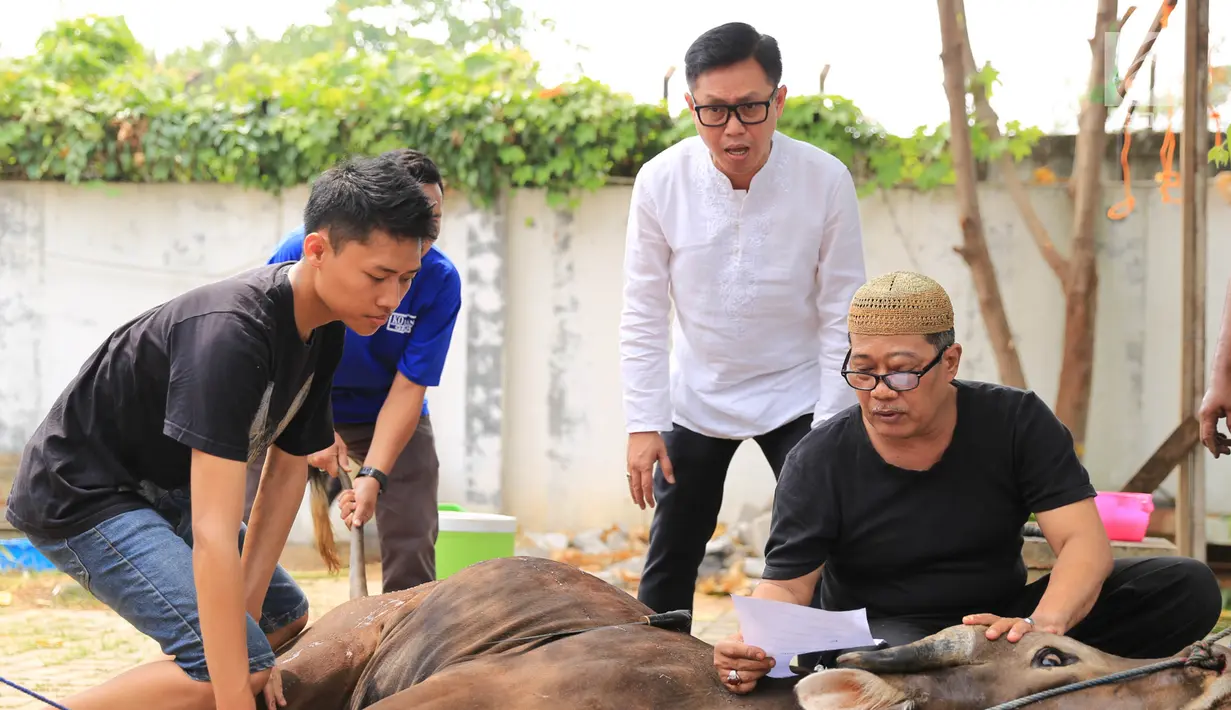 Presenter Eko Patrio saat melihat proses pemotongan hewan kurban di kawasan Cipinang, Jakarta, Jumat (1/9). Eko berharap kewajibannya sebagai umat Islam tetap bisa dilakukan setiap tahunnya. (Liputan6.com/Herman Zakharia)