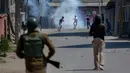 Pemuda Kashmir melempari batu ke arah tentara India saat merekam yang memprotes pembunuhan kelompok militan di Srinagar (4/1). (AP Photo / Dar Yasin)