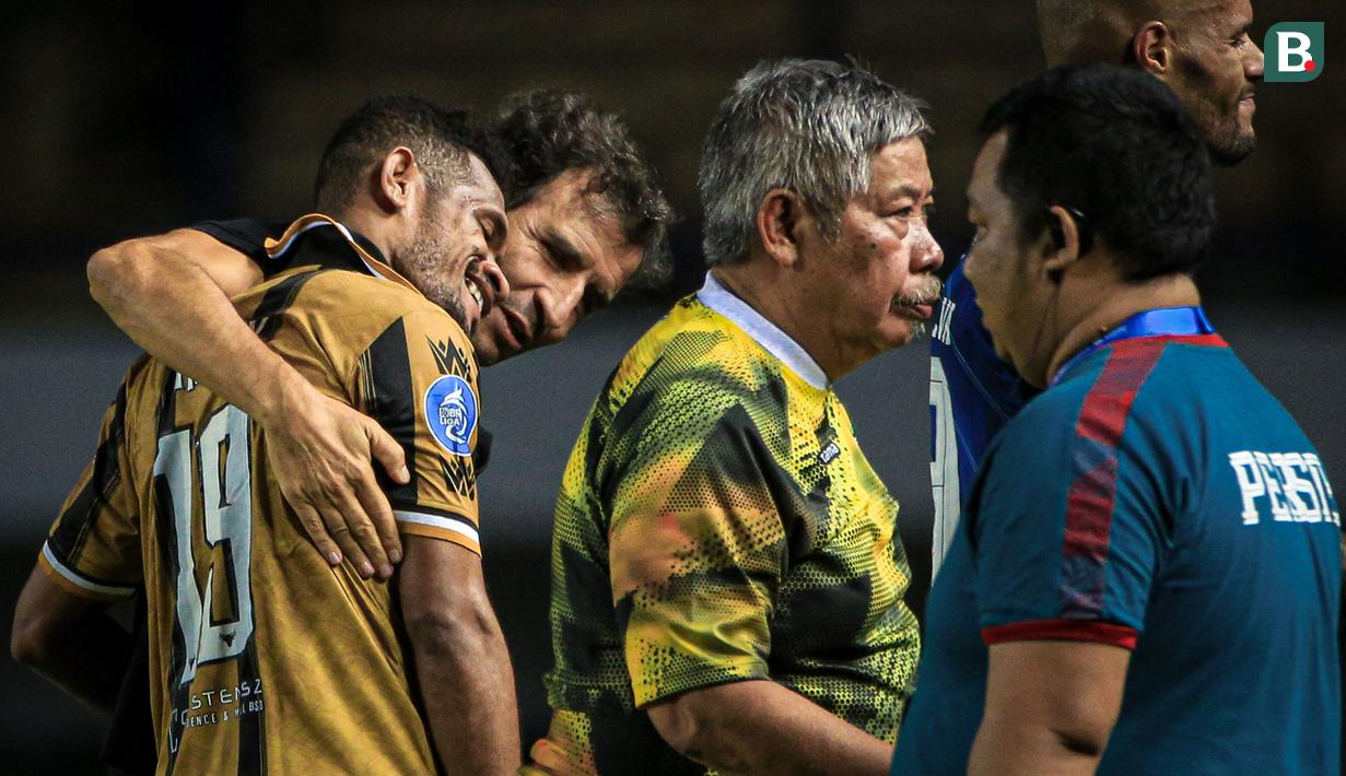 Pemain Dewa United, Ricky Kambuaya (kiri) mendapatkan pelukan dari mantan pelatihnya di Persib Bandung, Luis Milla pada laga lanjutan BRI Liga 1 2023/2024 antara Persib Bandung melawan Dewa United FC di Stadion Gelora Bandung Lautan Api (GBLA), Bandung, Jumat (14/07/2023). (Bola.com/Bagaskara Lazuardi)