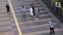 Seorang pria memotret para pejalan kaki di pedestrian kawasan Sudirman, Jakarta, Jumat (25/12/2020). Libur Natal dan Tahun Baru 2021 membuat jalanan di beberapa wilayah Ibu Kota terpantau lengang tanpa kemacetan. (Liputan6.com/Angga Yuniar)