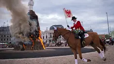 Anggota guild mengitari Boeoegg (manusia salju) yang terbakar di alun-alun Sechselaeuten, Zurich, Swiss (16/4). Acara ini untuk menandakan akhir dari festival musim dingin. (Ennio Leanza/Keystone via AP)