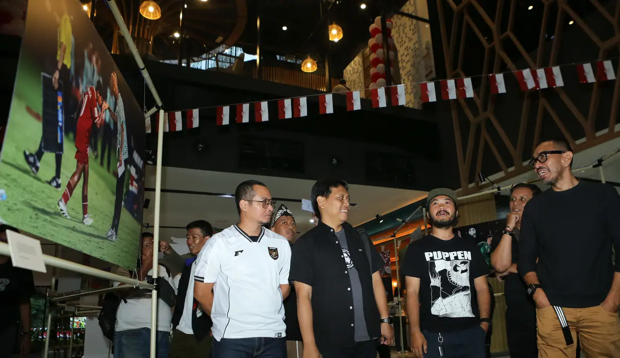 Anggota Exco PSSI, Arya Sinulingga, memandang foto saat menghadiri pembukaan pameran foto dan peluncuran kitab "90' & Beyond" di Sarinah, Jakarta Pusat, pada Minggu (24/8/2025). (Dok. PSSI Pers/PFI Jakarta)
