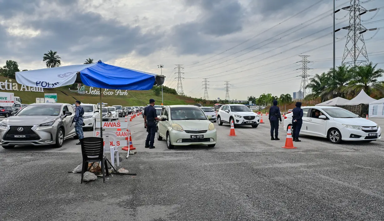Polisi dan tentara memeriksa kendaraan di pos pemeriksaan jalan tol Setia Alam di Selangor, Malaysia pada 5 Desember 2020. Pemerintah Malaysia akan memperpanjang perintah kontrol pergerakan orang di beberapa area hingga 20 Desember mendatang untuk mengendalikan COVID-19. (Xinhua/Chong Voon Chung)