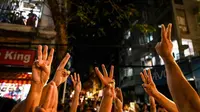 Demonstran anti-kudeta Myanmar di Yangon melayangkan salut tiga jari ala The Hunger Games, simbol pembangkangan terhadap pemerintahan totaliter (AFP PHOTO)
