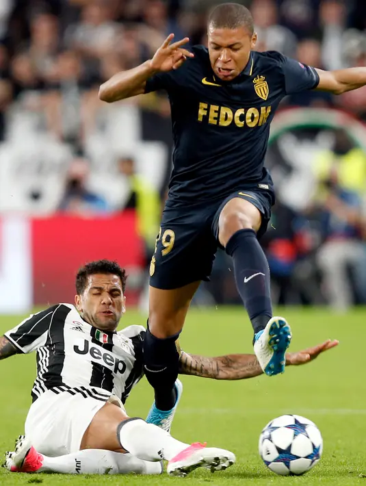 Penyerang AS Monaco, Kylian Mbappe (kanan) berusaha melewati bek Juventus, Daniel Alves pada leg kedua semifinal Liga Champions di Turin, Italia, (10/5). Juventus melangkah ke final setelah menang dengan aggregat 4-1. (AP Photo/Antonio Calanni)