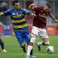 Penyerang AC Milan, Ante Rebic membawa bola dari kawalan pemain Parma, Matteo Darmian pada pertandingan lanjutan Liga Serie A Italia di Stadion San Siro di Milan, Italia (15/7/2020). AC Milan menang telak 3-1 atas Parma. (AP Photo/Luca Bruno)