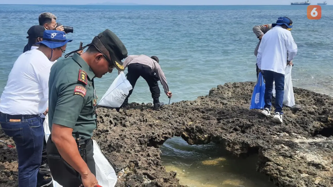 TNI, Polri, Masyarakat dan Pegawai PT Chandra Asri Petrochemical Bersihkan Spah Di Pantai Paku, Anyer. (Kamis, 15/09/2022). (Yandhi Deslatama/Liputan6.com)