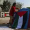 Sejumlah orang yang tergabung dalam Koalisi Musisi untuk Gaza melakukan aksi mendirikan tenda di depan Kedutaan Besar Amerika Serikat, Jakarta, Jumat (10/5/2024). (Liputan6.com/Herman Zakharia)