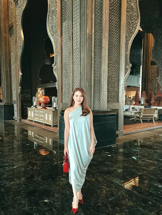 Chen Giovani juga tampil dengan dress one shoulder warna hijau mint, dipadukan heels maroon serasi dengan lady dior bag warna merah.