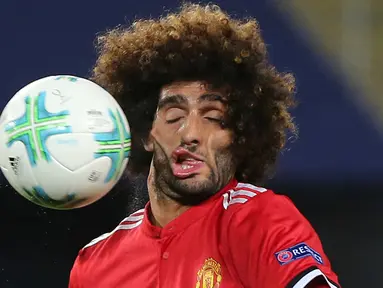 Mimik wajah gelandang Manchester United (MU), Marouane Fellaini saat terkena benturan bola dalam laga Piala Super Eropa melawan Real Madrid di Macedonia, Selasa (8/8). Foto wajah Fellaini yang menjadi aneh itu viral di media sosial. (AP/Boris Grdanoski)