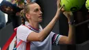 Petenis Republik Ceko, Petra Kvitova menandatangi bola yang disodorkan penggemarnya setelah mengalahkan Irina-Camelia Begu dari Rumania dalam babak kedua  turnamen Australia Terbuka di Melbourne, Rabu (16/1). (AP Photo/Andy Brownbill)