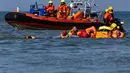 Petugas gendarmerie Prancis mengevakuasi jenazah seorang pria yang ditemukan di perairan dekat Pantai Neufchâtel-Hardelot, Pas-de-Calais, Rabu (23/9/2026). Penemuan jenazah terjadi setelah upaya penyeberangan sejumlah migran menuju Inggris melalui Selat Inggris. (Sameer Al-DOUMY/AFP)