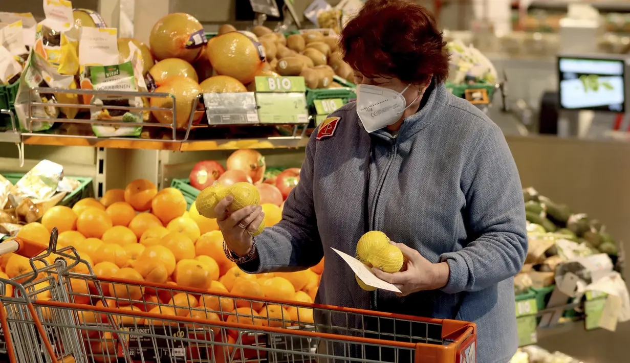 Seseorang mengenakan masker FFP2 jenis respirator saat berbelanja di supermarket di Wina, Austria, Senin (25/1/2021). Mulai 25 Januari 2021, warga Austria diwajibkan mengenakan masker FFP2 di supermarket, apotek, pompa bensin, dan di transportasi umum. (AP Photo/Ronald Zak)
