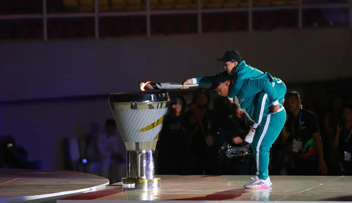 Atlet Para Tenis Meja, Muhammad Anas Mustofa digendong oleh Atlet Para Atletik, Farid Surdin dalam Upacara Pembukaan Pekan Paralimpiade Nasional di Stadion Manahan, Solo, Minggu (6/10/2024). (PB PEPARNAS/Dwi Prasetya)