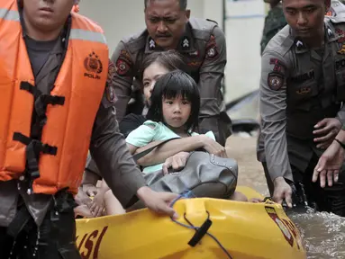 Petugas gabungan mengevakuasi anak-anak saat banjir merendam permukiman Cipinang Melayu, Jakarta, Rabu (1/1/2020). Ratusan rumah warga di Kelurahan Cipinang Melayu terendam banjir hingga ketinggian leher orang dewasa sejak dini hari tadi dan telah menewaskan dua warga. (merdeka.com/Iqbal S Nugroho)