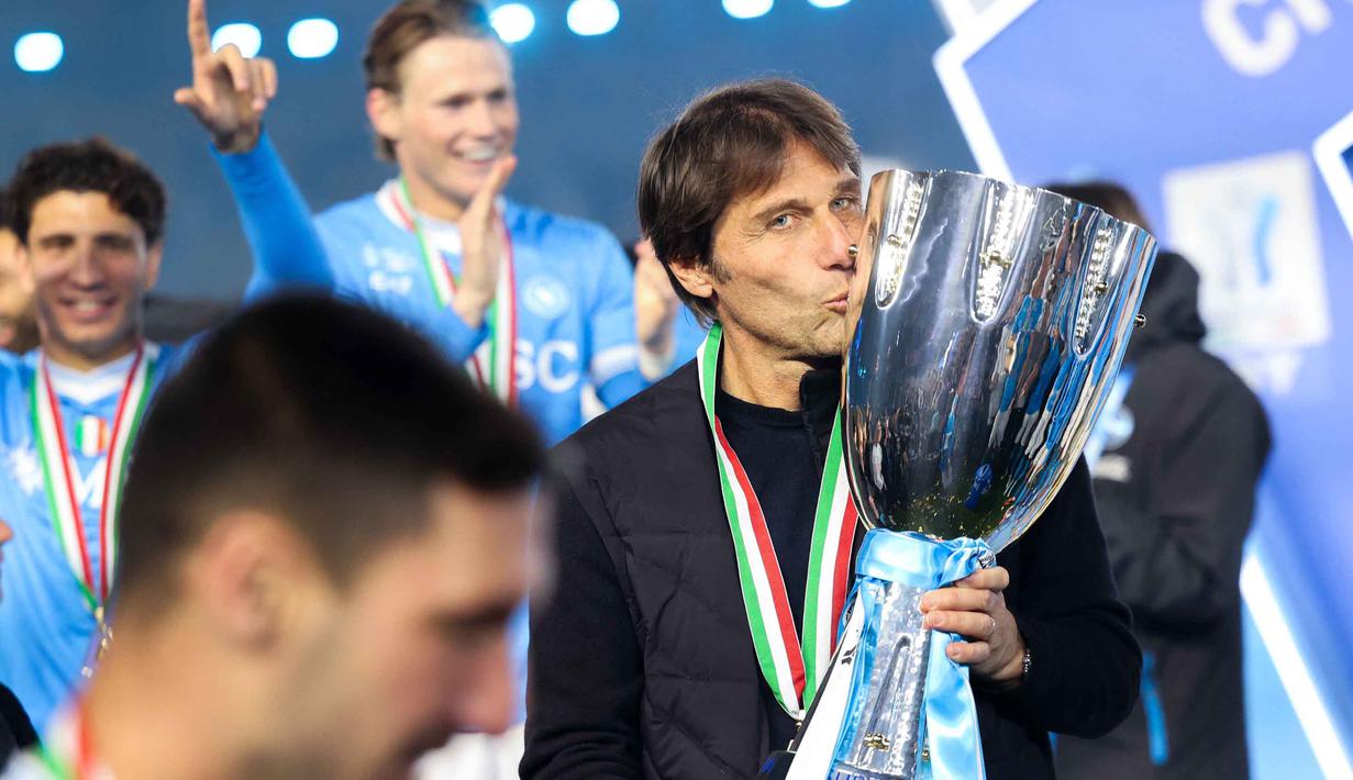 Kemenangan ini tidak hanya menambah koleksi trofi Piala Super Italia di lemari klub, tetapi juga menjadi penegasan atas loyalitas para pemain terhadap sang pelatih, Antonio Conte. Tampak dalam foto, pelatih Napoli asal Italia, Antonio Conte, memegang trofi setelah pertandingan final Piala Super Italia melawan Bologna di Stadion King Al-Awwal Park, Riyadh pada Senin 22 Desember 2025 malam waktu setempat. (Fayez NURELDINE/AFP)