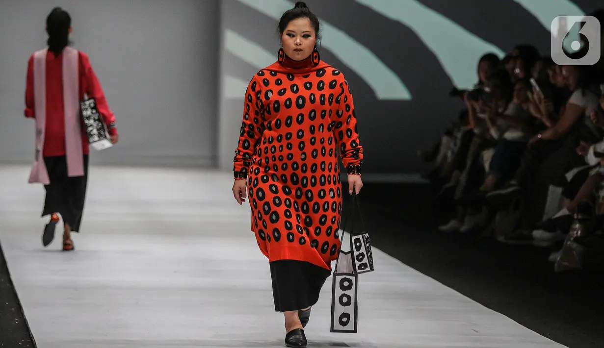 Model disabilitas memperagakan busana rancangan kolaborasi Cotton Ink x Intoart yang digawangi British Council pada Jakarta Fashion Week 2020 di Senayan, Kamis (24/10/2019). Kolaborasi ini menampilkan model disabilitas yang terdiri dari down syndrome, tuna daksa dan tuli. (Liputan.com/Johan Tallo)