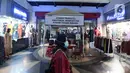 Pengunjung berjalan melewati toko-toko baju di Pasar Tanah Abang Blok A, Jakarta, Rabu (19/5/2021). Pada hari ini, Pasar Tanah Abang kembali dibuka setelah ditutup sementara selama sepekan pada 12-18 Mei 2021. (Liputan6.com/Herman Zakharia)