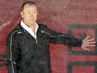 Former England and Newcastle footballer Alan Shearer stands in a glass advertising board in London, on February 27, 2008, offering fans around the world the chance to have their say about football. AFP PHOTO/SHAUN CURRY