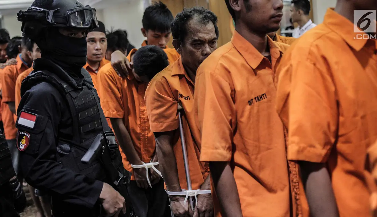 Para tersangka dihadirkan saat rilis sejumlah kasus kejahatan di Resmob Polda Metro Jaya, Rabu (6/3). Pada rilis gabungan itu petugas berhasil mengungkap sebanyak lima kasus diantaranya dua tersangka terpaksa ditembak kakinya. (Liputan6.com/Faizal Fanani)
