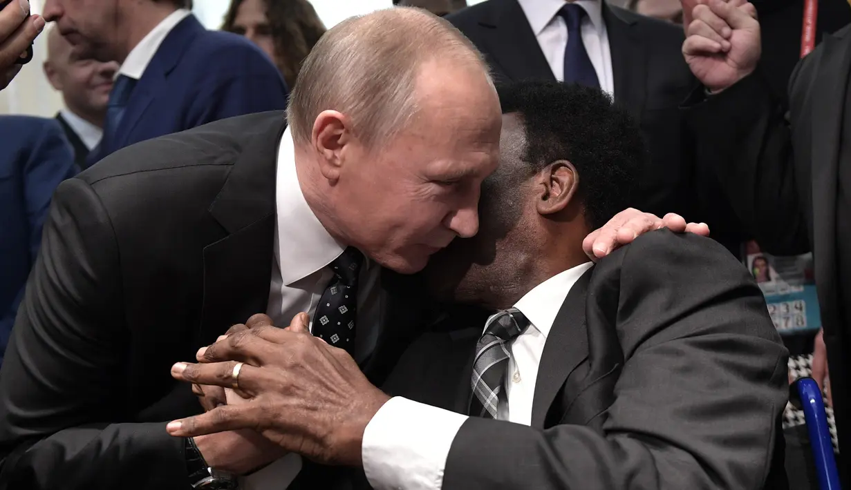 Presiden Rusia Vladimir Putin memeluk legenda sepak bola Brasil, Pele saat menghadiri undian Piala Dunia 2018 di Moskow, Rusia (1/12). Undian Piala Dunia 2018 dibuka secara resmi oleh Presiden Rusia Vladimir Putin. (AFP Photo/Sputnik/Alexey Nikolsky)
