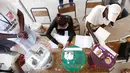 Petugas mencatat jumlah warga yang menggunakan hak pilihnya saat pemilihan Presiden Gambia di Banjul, Gambia (1/12). Pemilihan menggunakan kelereng ini dikarenakan tingginya angka buta huruf di negara tersebut. (Reuters/Thierry Gouegnon)